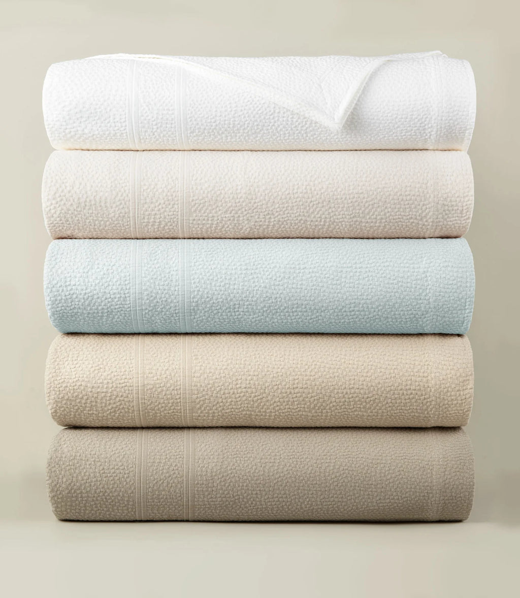 Montauk Matelassé Coverlet all colorways stacked – luxury bedding – Peacock Alley