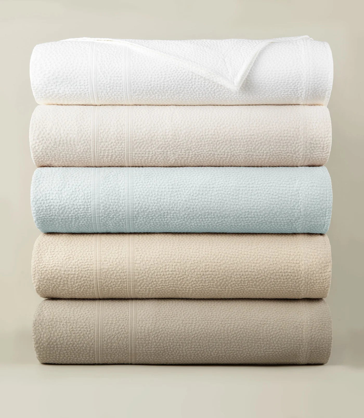 Montauk Matelassé Coverlet all colorways stacked – luxury bedding – Peacock Alley