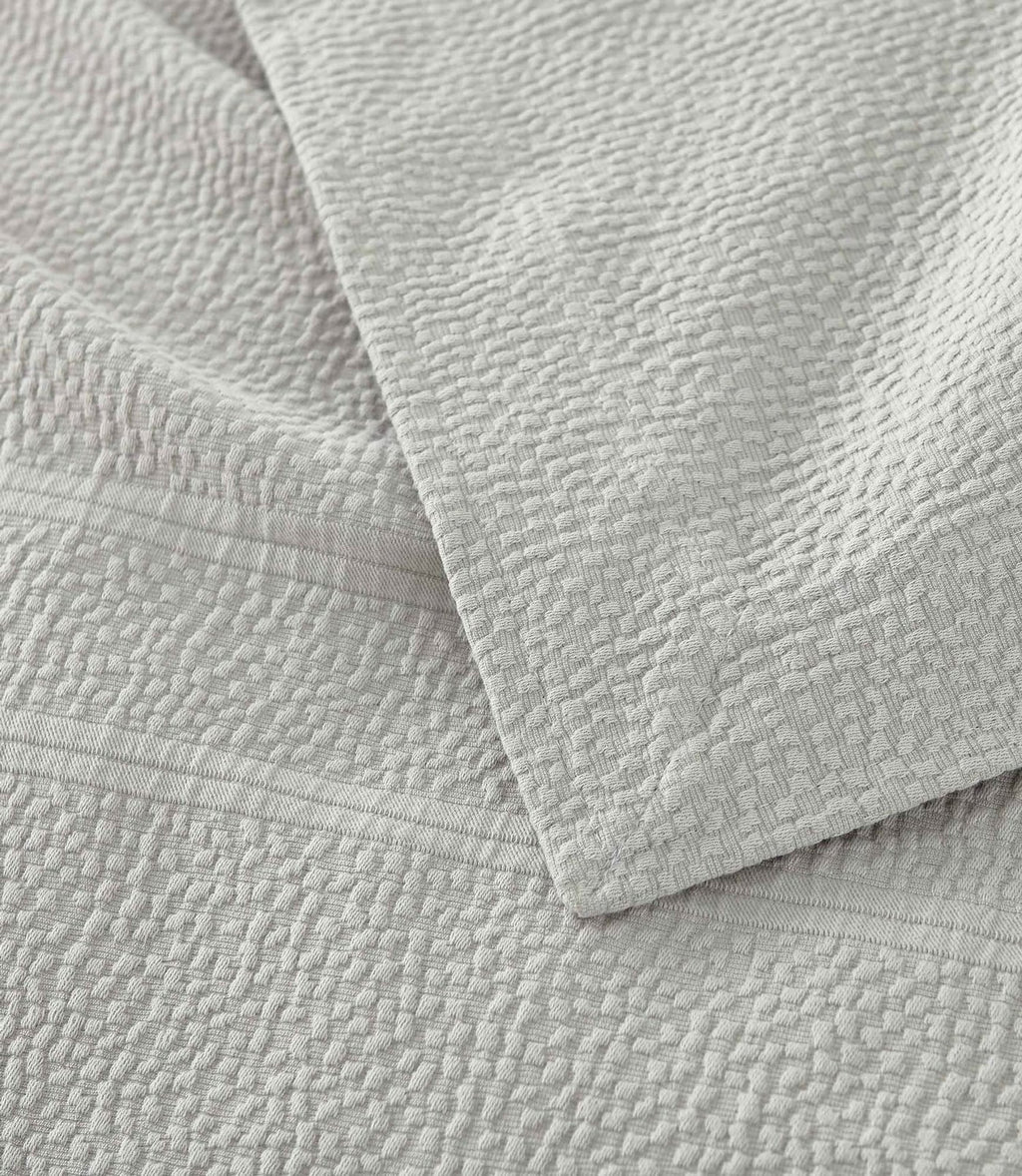 Montauk Matelassé Coverlet corner detail in Gray – pebble texture – Peacock Alley