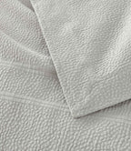 Montauk Matelassé Coverlet corner detail in Gray – pebble texture – Peacock Alley