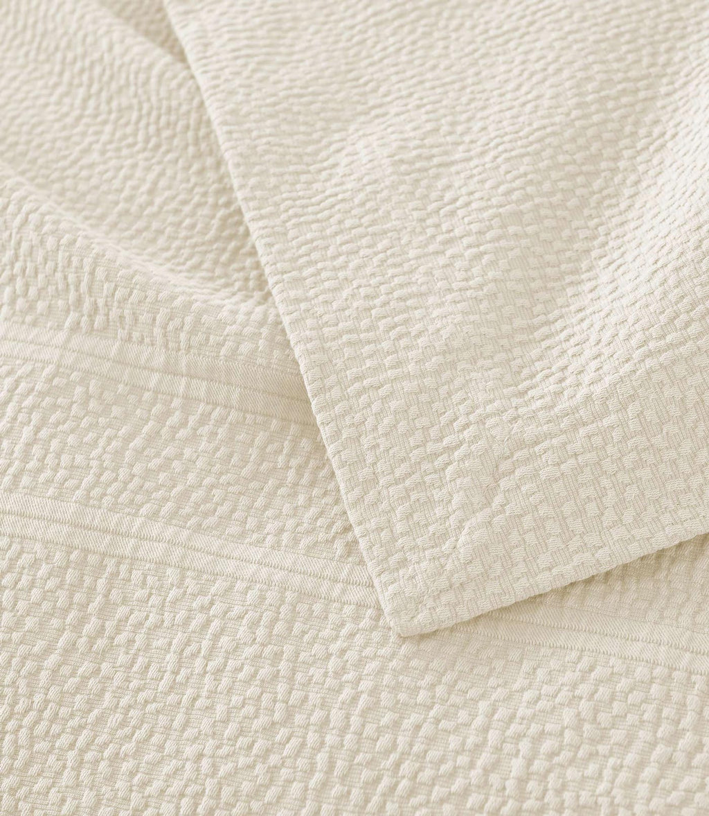 Montauk Matelassé Coverlet corner detail in Gray – pebble texture – Peacock Alley