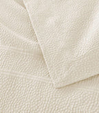 Montauk Matelassé Coverlet corner detail in Gray – pebble texture – Peacock Alley