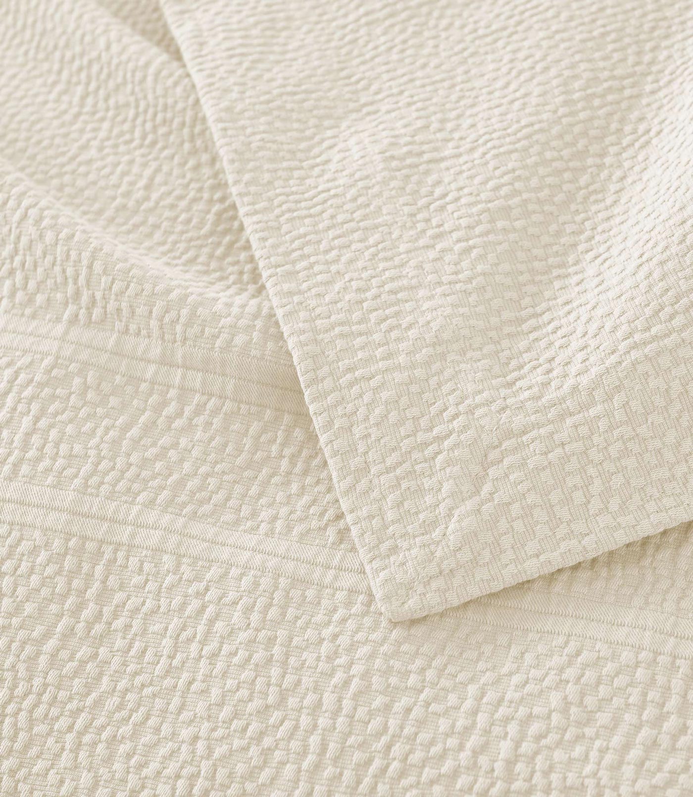 Montauk Matelassé Coverlet corner detail in Gray – pebble texture – Peacock Alley