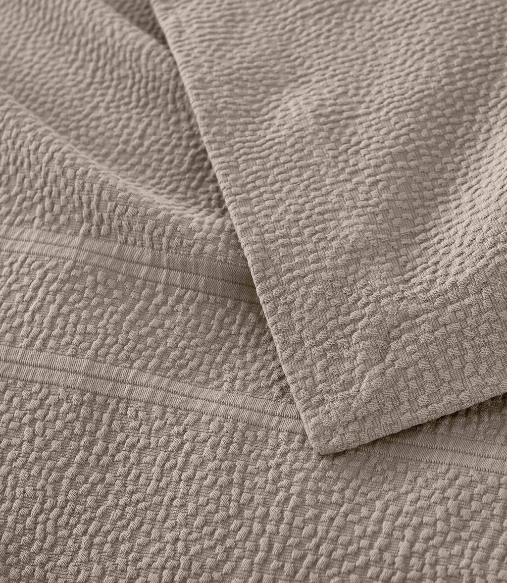 Montauk Matelassé Coverlet corner detail in Gray – pebble texture – Peacock Alley