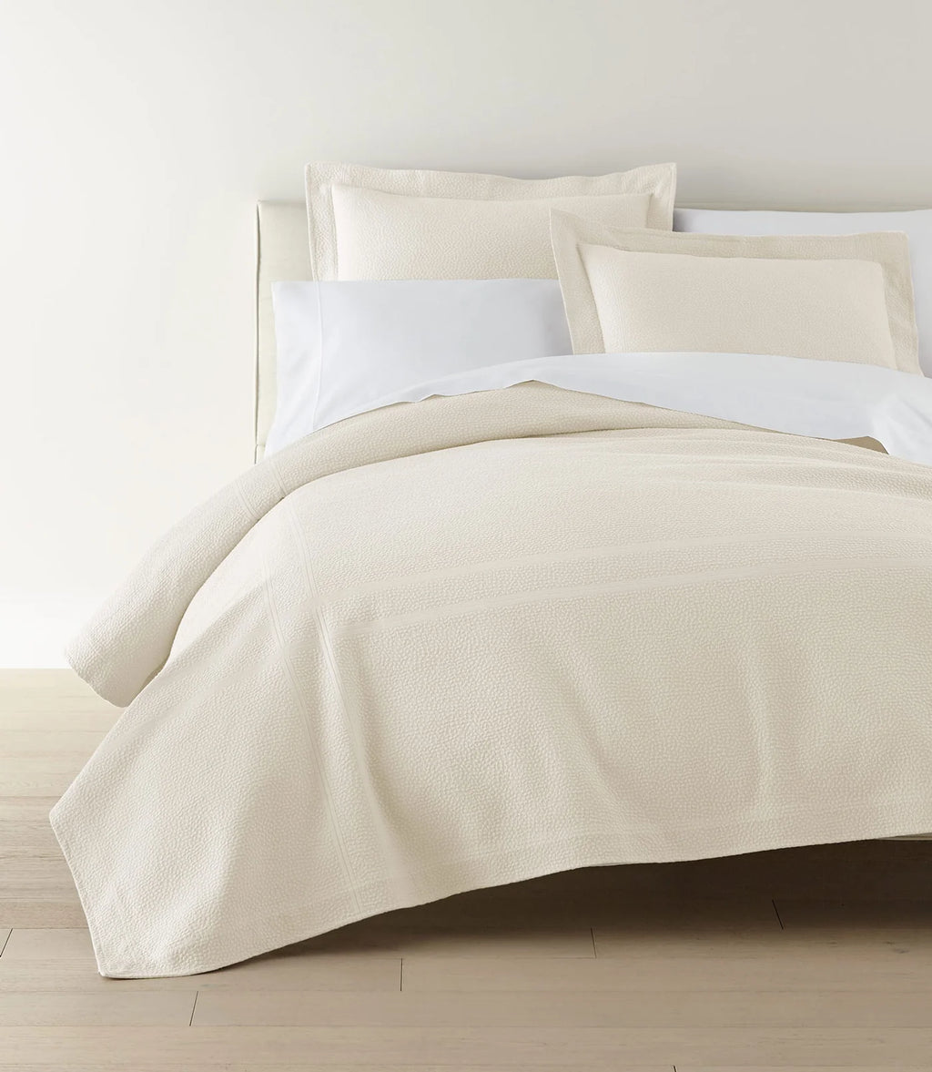 Montauk Matelassé Coverlet lifestyle foot view in White – woven in Portugal – Peacock Alley