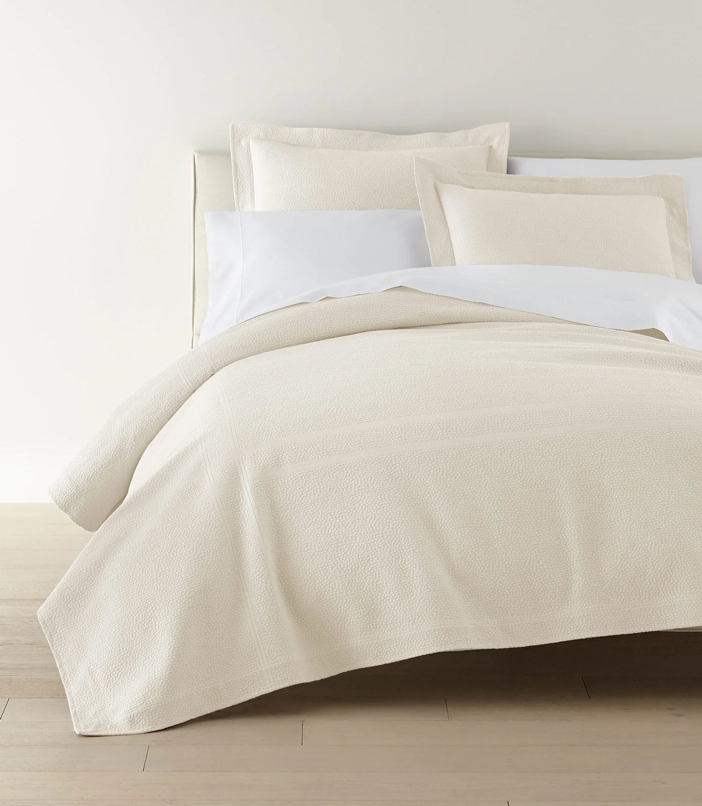 Montauk Matelassé Coverlet lifestyle foot view in White – woven in Portugal – Peacock Alley