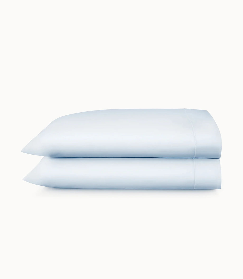 Two light blue pillowcases on a white background