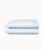 Two light blue pillowcases on a white background
