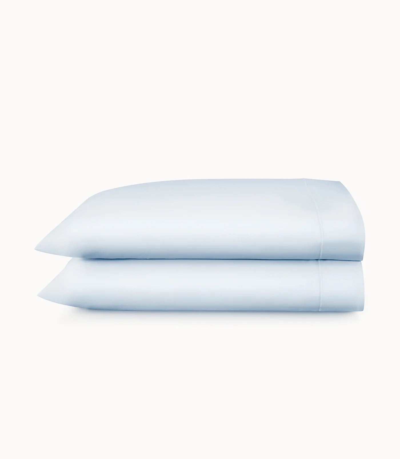 Two light blue pillowcases on a white background