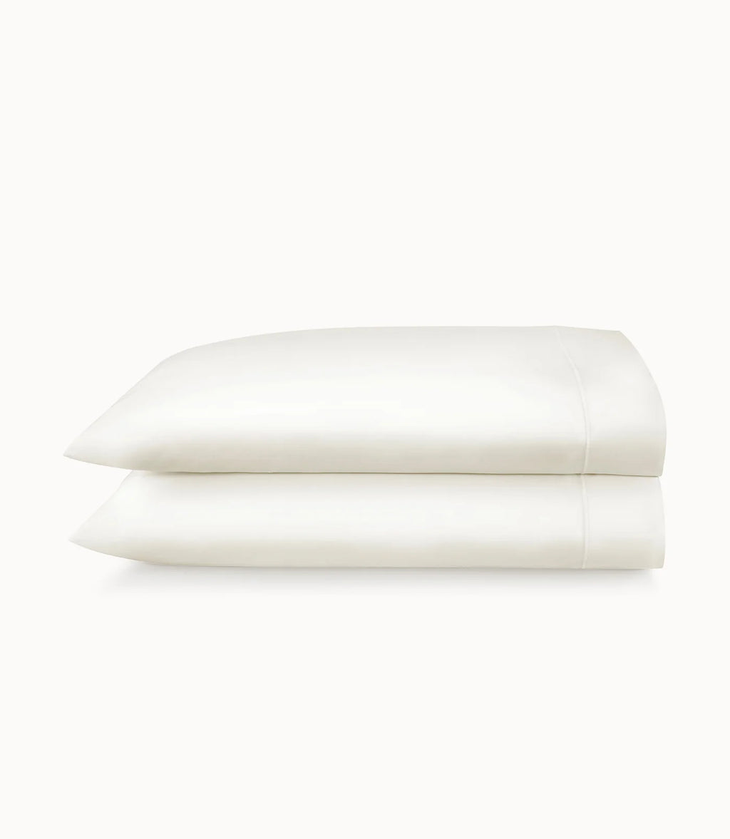Folded white pillowcases on a white background