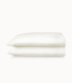 Folded white pillowcases on a white background