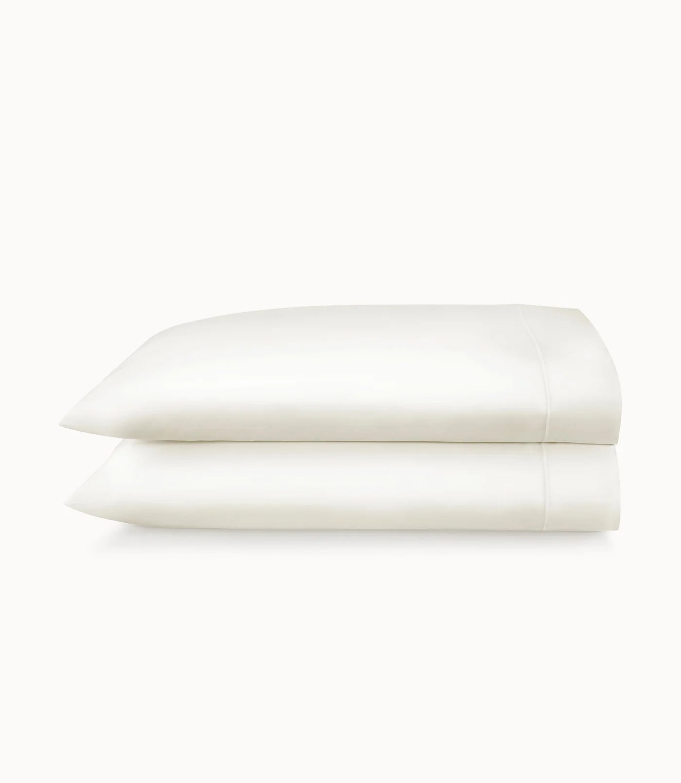 Folded white pillowcases on a white background