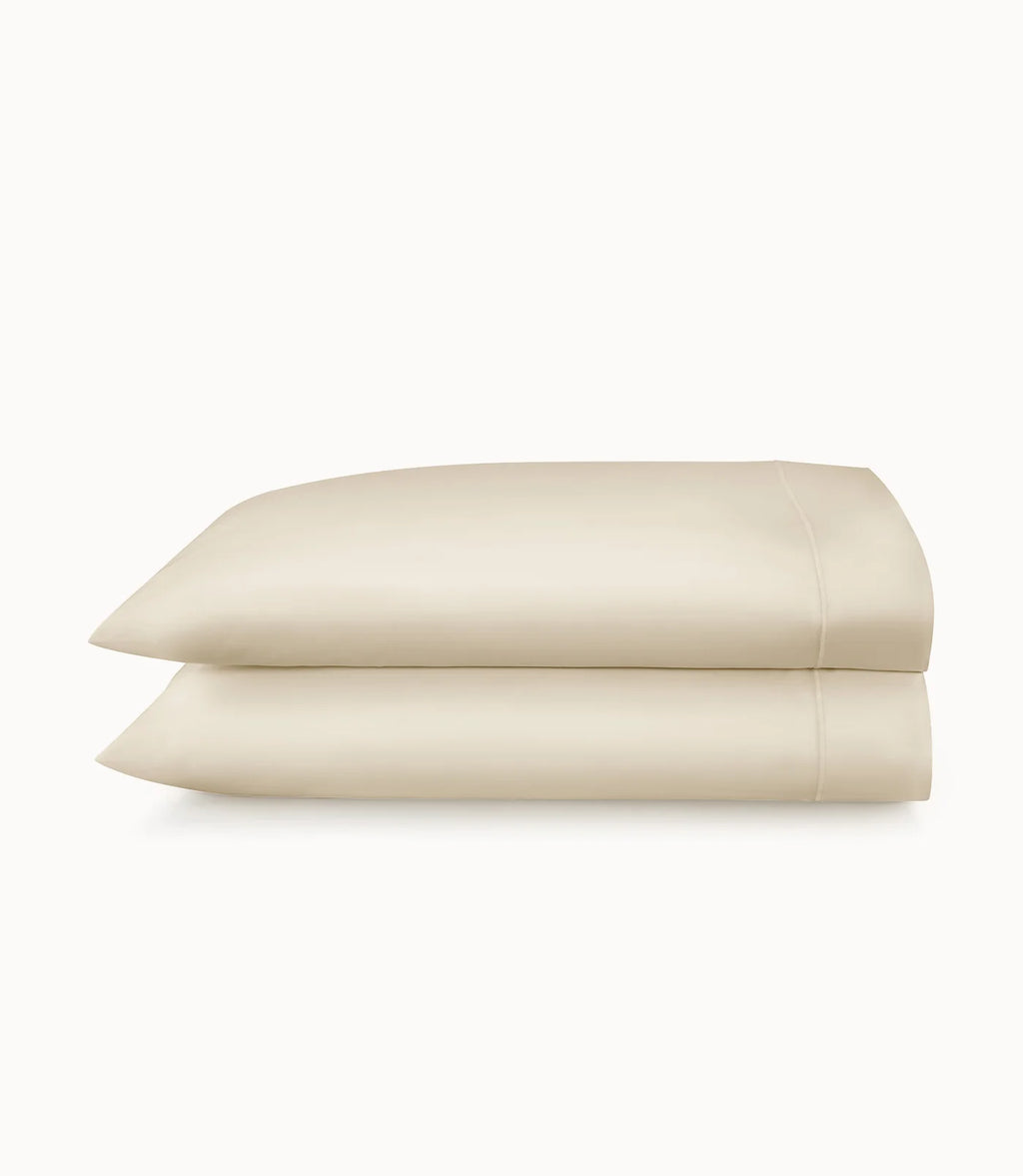 Two beige pillows stacked on a white background