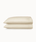 Two beige pillows stacked on a white background