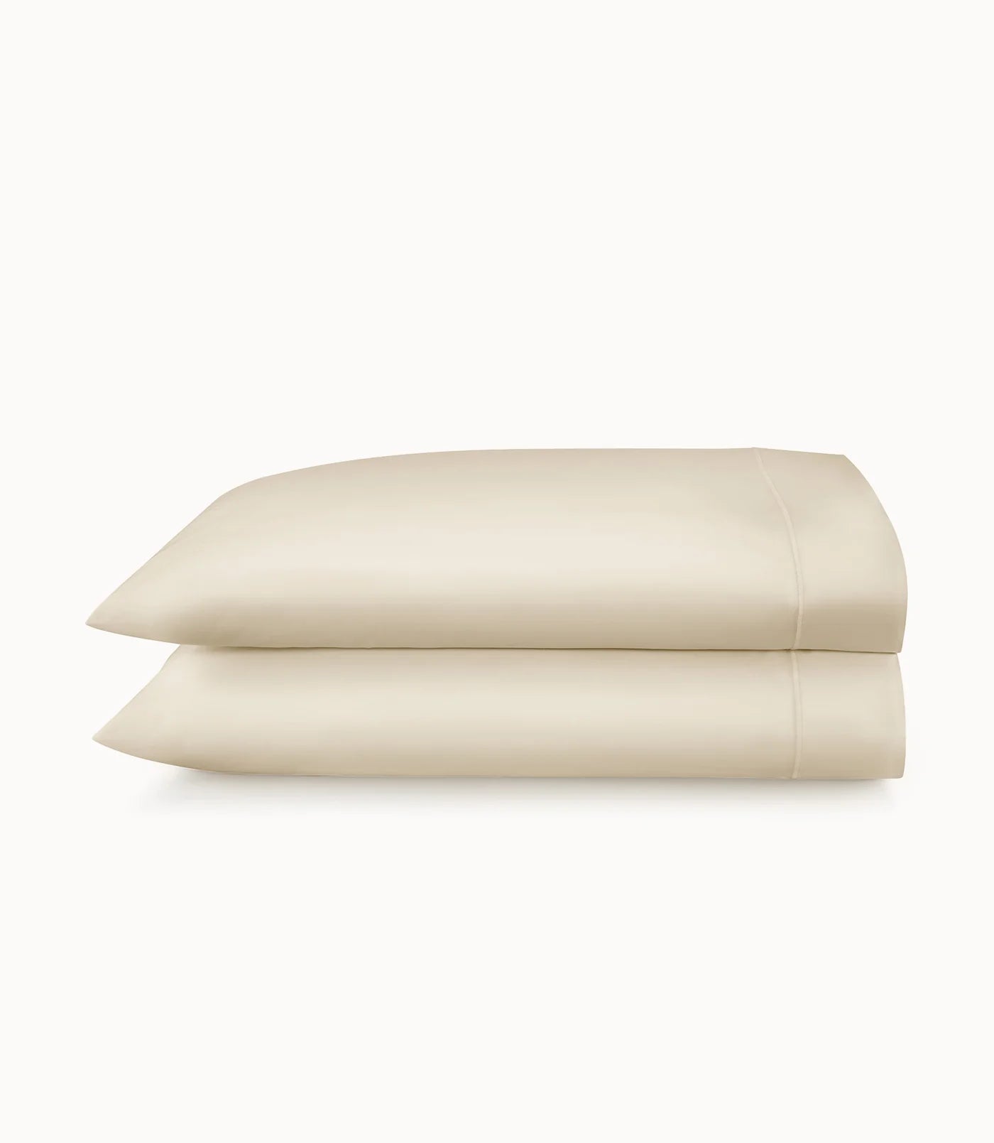 Two beige pillows stacked on a white background
